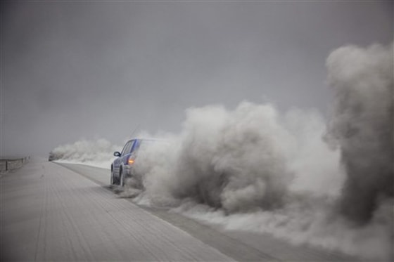 A car is seen driving through the ash from the volcano eruption under the Eyjafjallajokull glacier in Iceland on Friday.